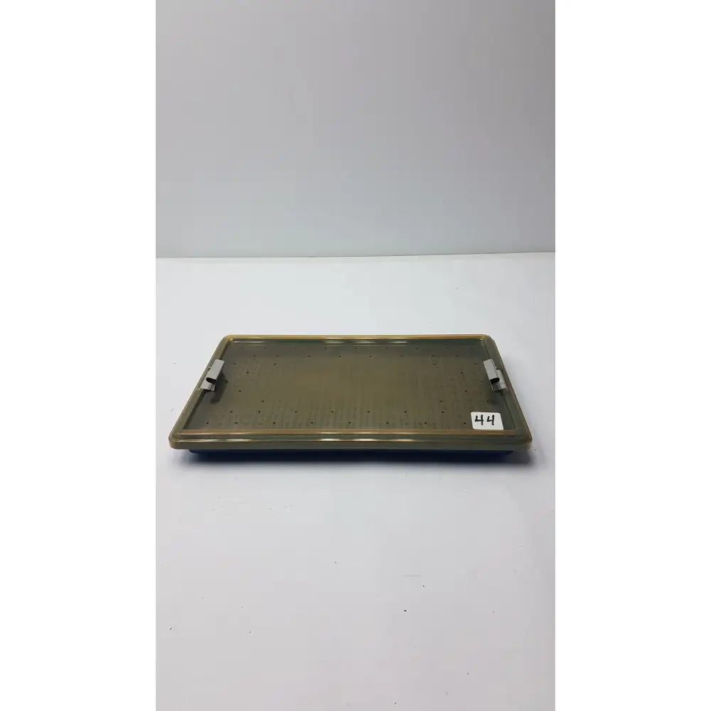 Olive-green plastic sterilization tray with silicone finger mat perforated surface and two metallic side handles