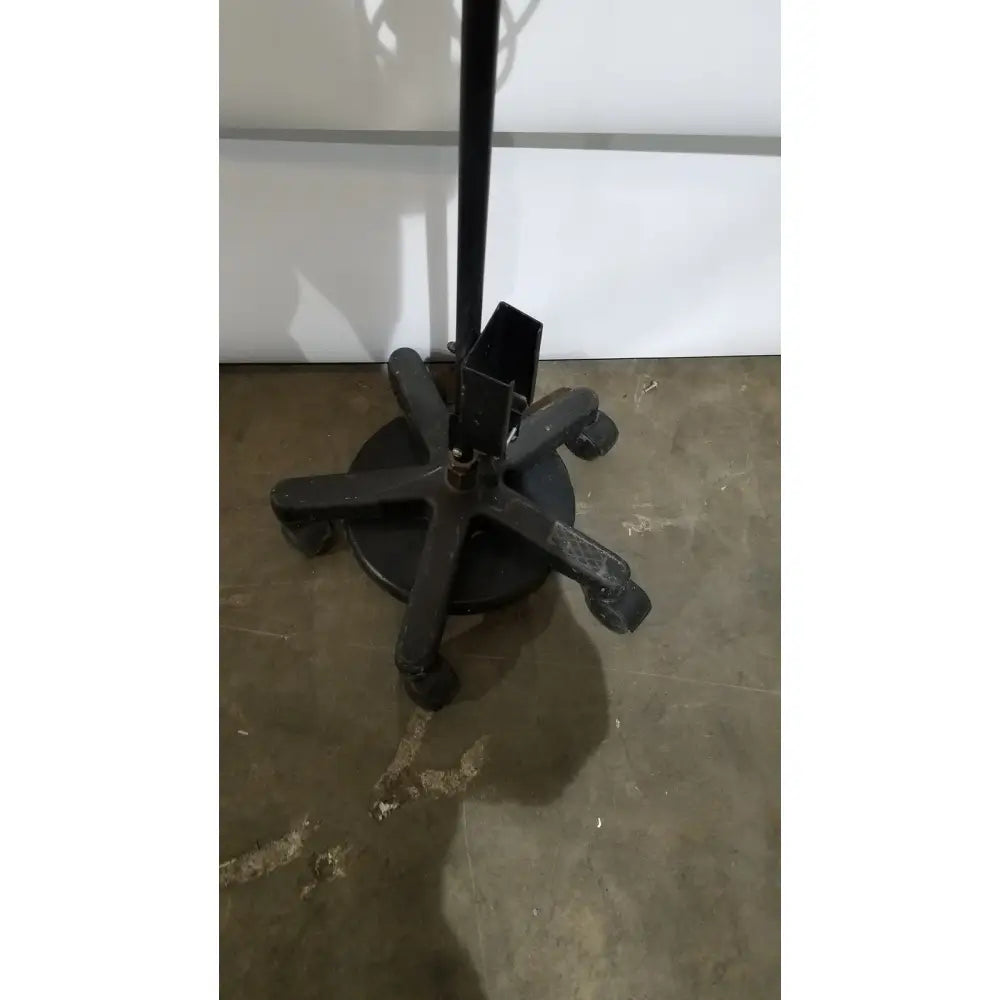 Black metal office chair base with five casters supporting a portable magnifying light lamp ac110v 60hz rolling stand