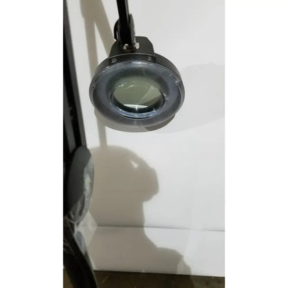 Black magnifying glass with circular lens and metallic frame on adjustable arm light lamp ac110v 60hz portable use