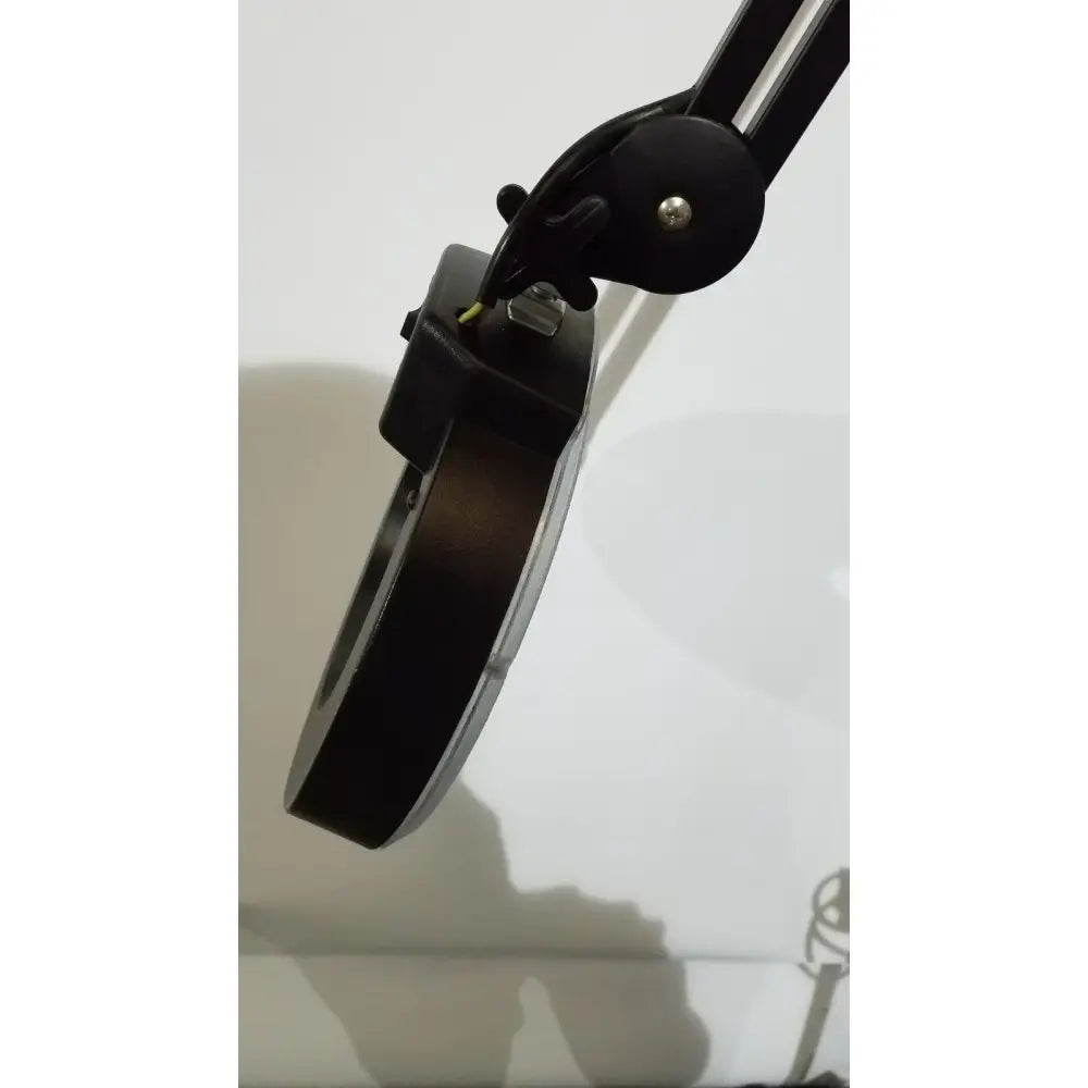 Black adjustable desk light lamp ac110v 60hz with circular magnifying lens metallic accents and rolling stand