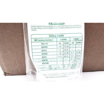 Back side of a clear package containing posey quick dry white slippers with non slip rubber soles in size large lot of 50