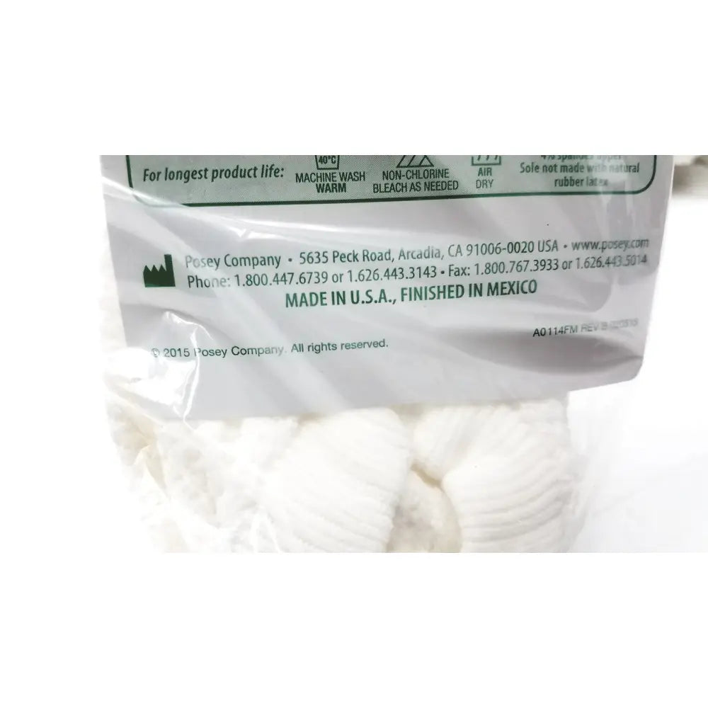 Back side of white plastic packaging for posey quick dry slippers with care instructions and manufacturing details