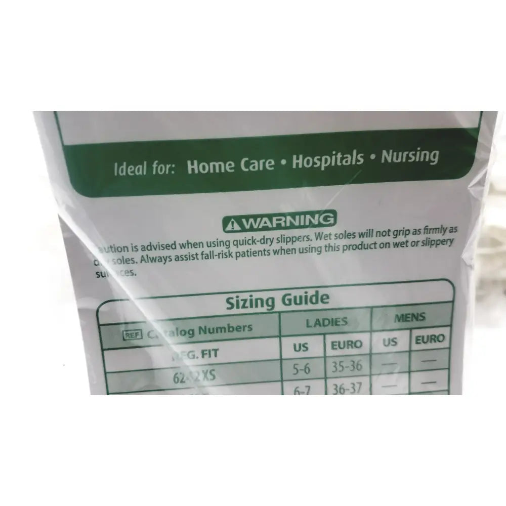 White plastic packaging of posey quick dry slippers with green labeling slip rubber soles and sizing guide table back side