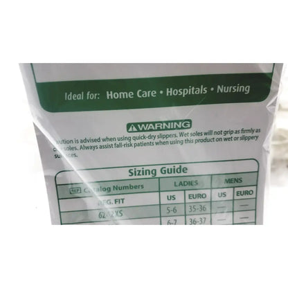 White plastic packaging of posey quick dry slippers with green labeling slip rubber soles and sizing guide table back side