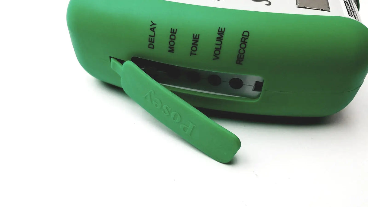 Green silicone-covered posey sitter elite patient fall monitor alarm with labeled control buttons for volume and record functions