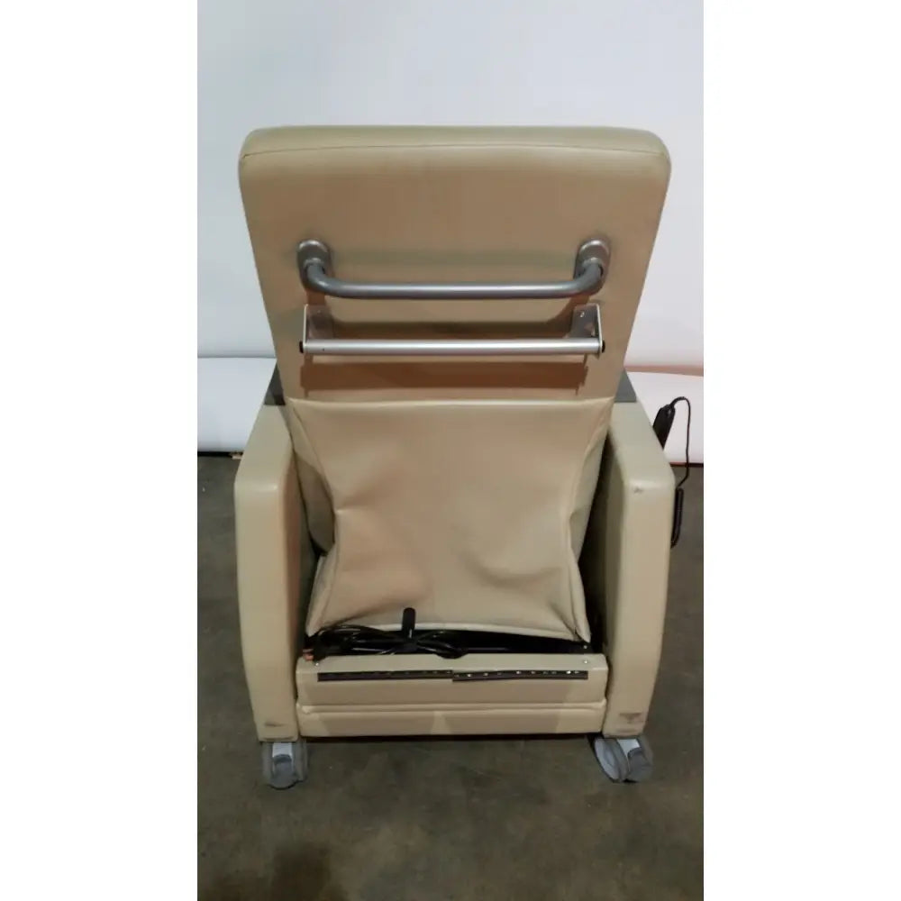 Beige upholstered power recovery recliner with metal armrest bars and caster wheels featuring hand control