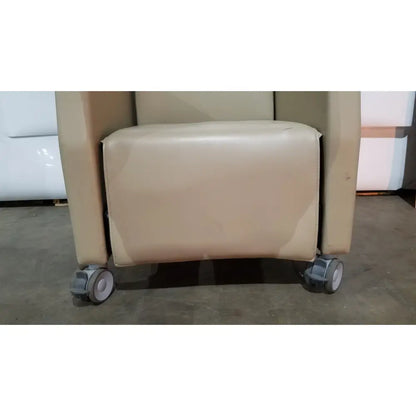 Beige leather power recovery recliner with caster wheels and hand control for enhanced recovery comfort