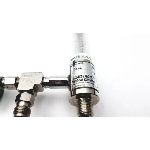 Silver metallic precision medical regulator gauge with clear cylindrical body and chemetron medical division label