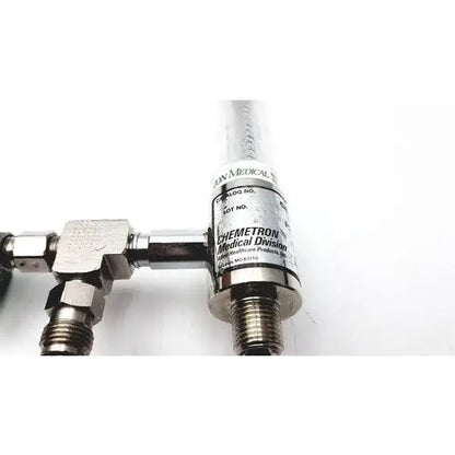 Silver metallic precision medical regulator gauge with clear cylindrical body and chemetron medical division label