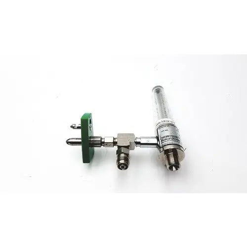 Silver metallic precision medical regulator with green plastic clamp and medical regulator gauge white label attached