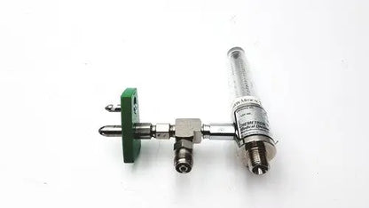 Silver metallic precision medical regulator with green plastic clamp and medical regulator gauge white label attached