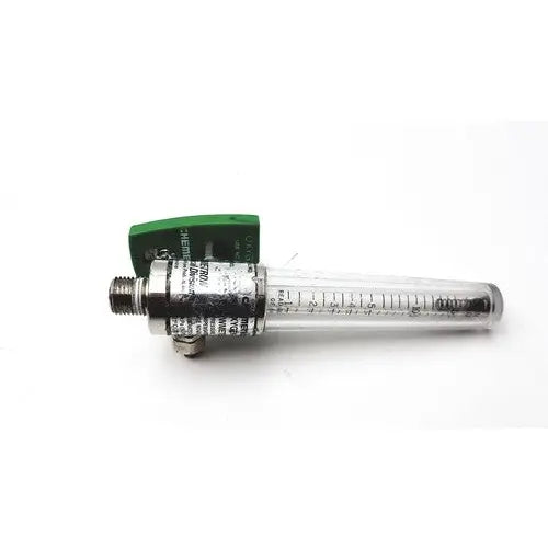 Clear glass tube flow meter with green plastic housing and metallic fittings in a precision medical regulator gauge