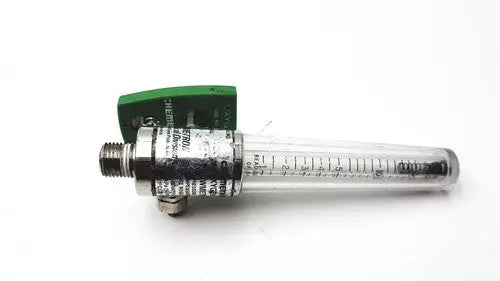 Clear glass tube flow meter with green plastic housing and metallic fittings in a precision medical regulator gauge