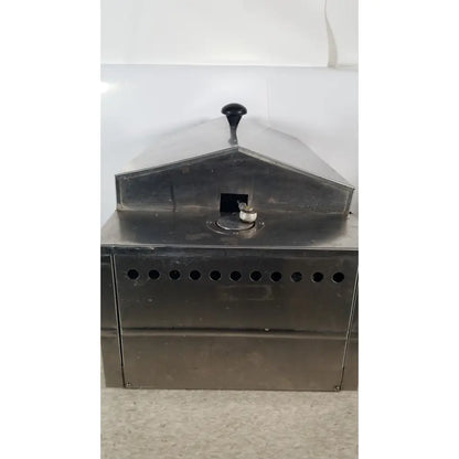 Precision scientific metabolic shaking incubator featuring an industrial stainless steel coffee roaster with black handle and ventilation holes