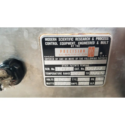 Black and silver metal plaque engraved with precision scientific metabolic shaking incubator 66722 identification text