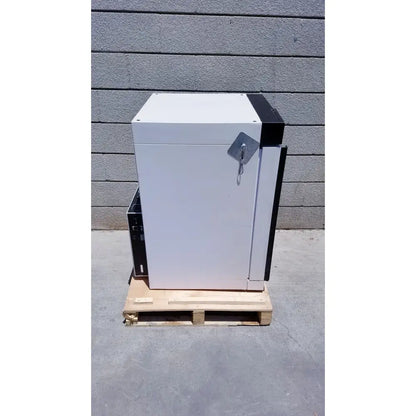 White and black industrial-grade metal safe with padlock on wooden pallet for precision scientific napco 6101fc-or water jacketed co2 incubator