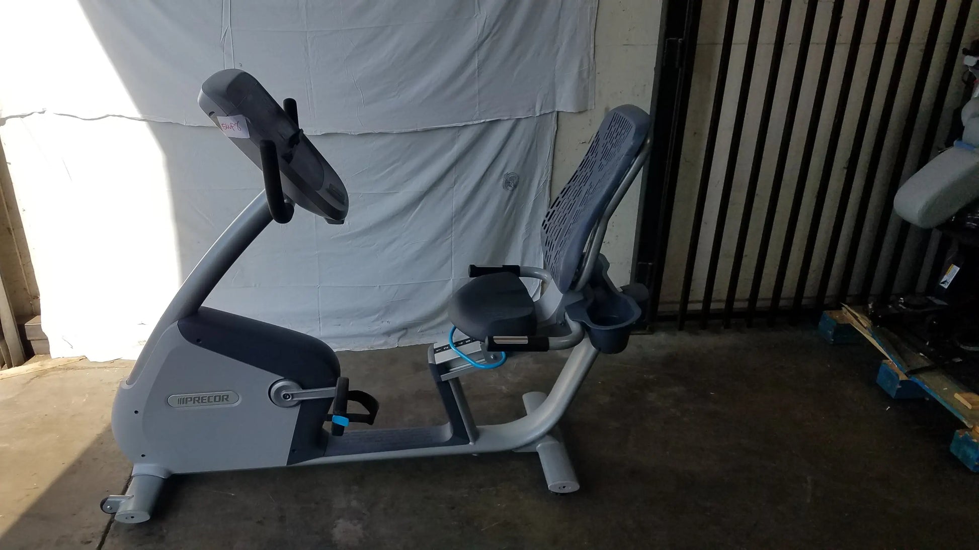 Gray and black recumbent exercise bike featuring a digital precor console for effective indoor workouts