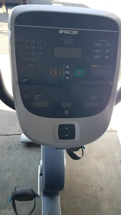 Gray and black precor recumbent exercise bike console with digital display numeric keypad and control buttons for workout tracking