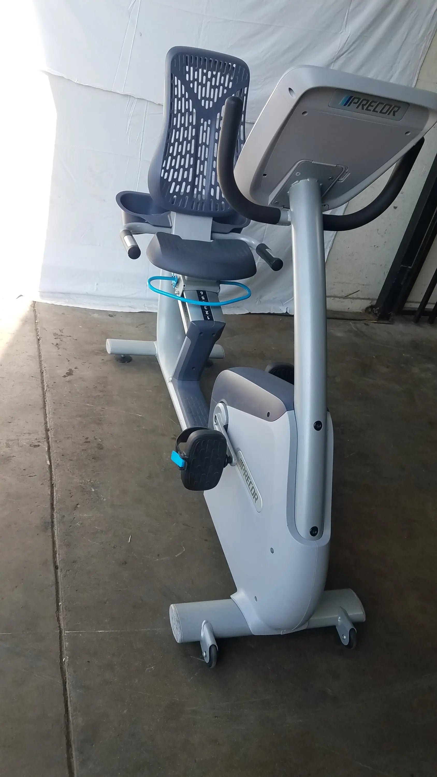 Gray and black precor recumbent exercise bike with mesh backrest and precor console for comfortable workouts