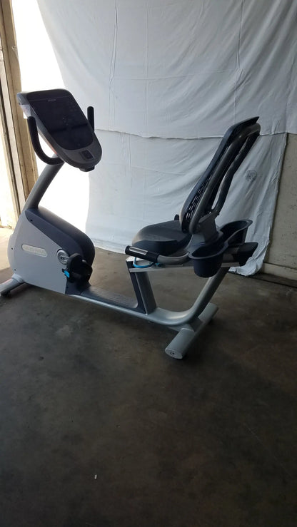 Gray and black recumbent exercise bike featuring precor console with digital display for indoor fitness workouts