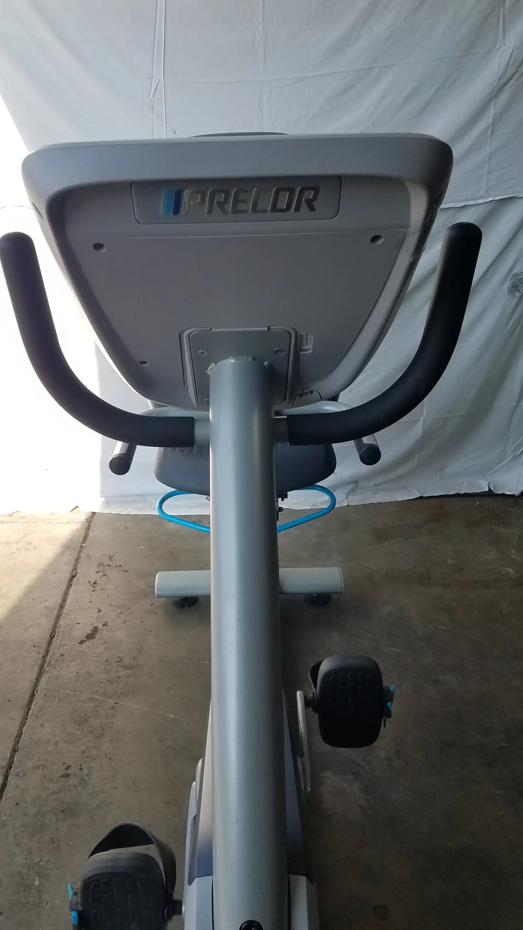 Gray and black precor recumbent exercise bike with precor console padded handlebars and sleek modern design