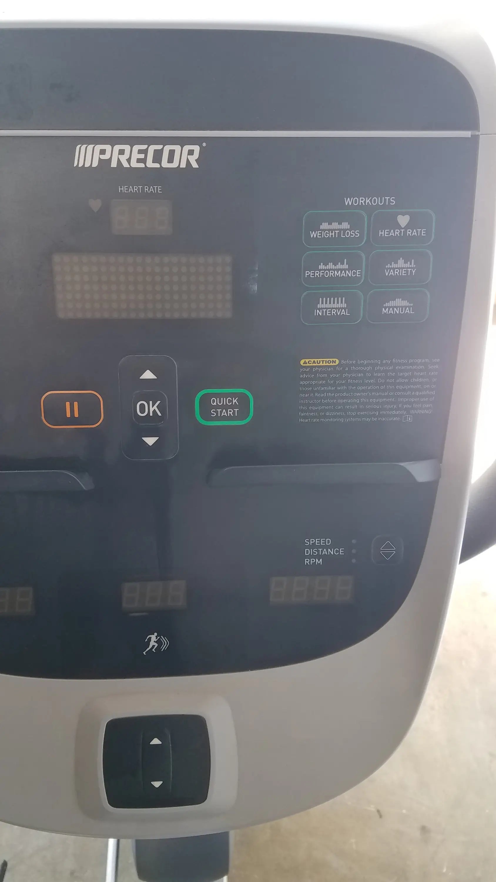 Gray and black precor console with digital display workout buttons and control knobs on precor recumbent exercise bike