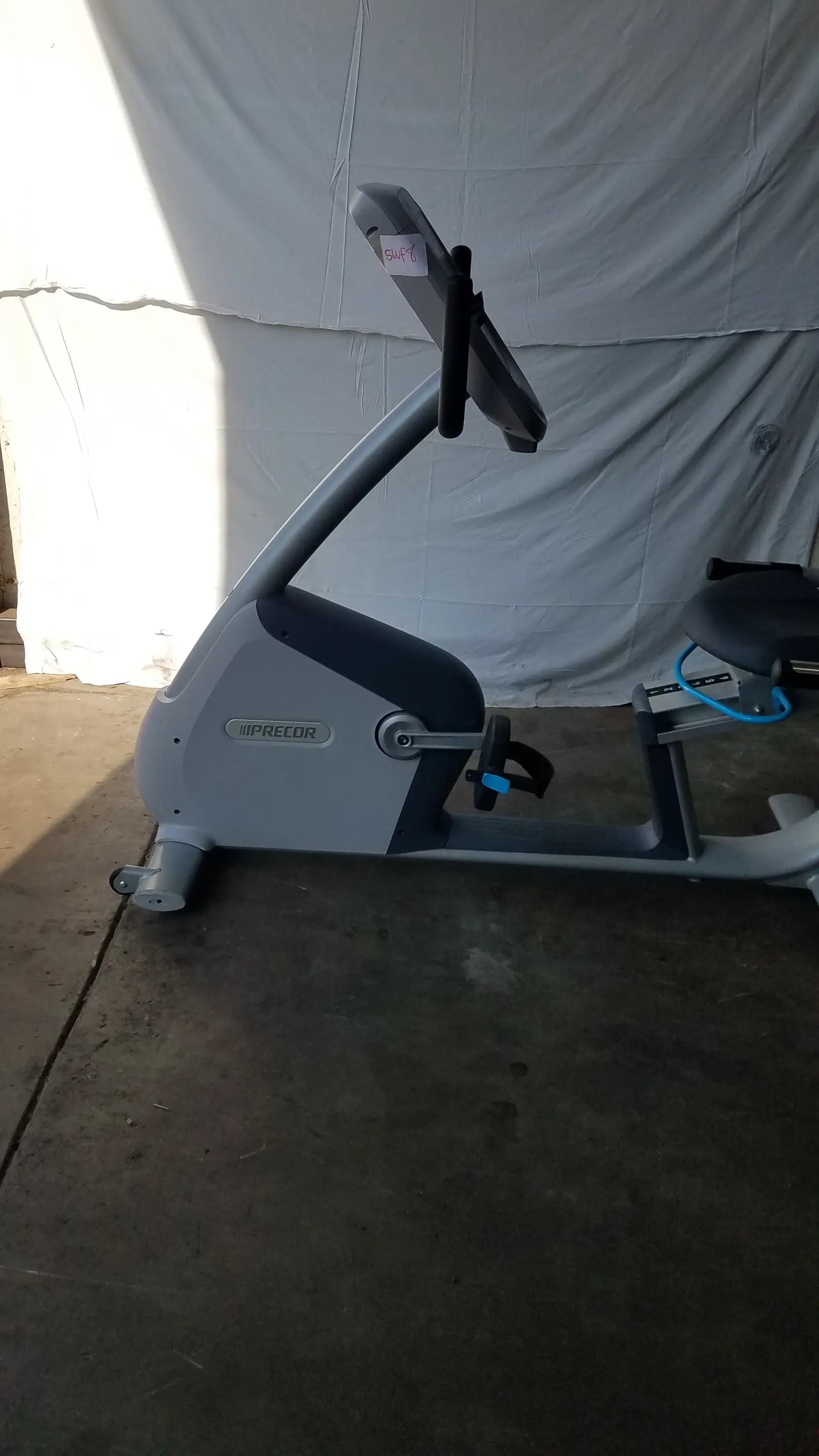 Gray and black upright exercise bike with precor console digital display panel for recumbent exercise bike use