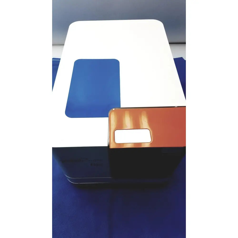 White and blue rectangular proteinsimple wes analyzer system with small orange component for reuse medical applications