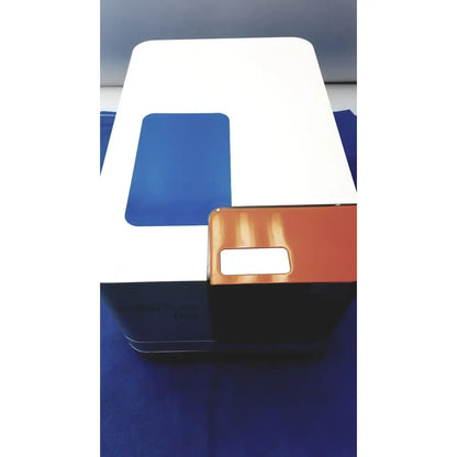White and blue rectangular proteinsimple wes analyzer system with small orange component for reuse medical applications