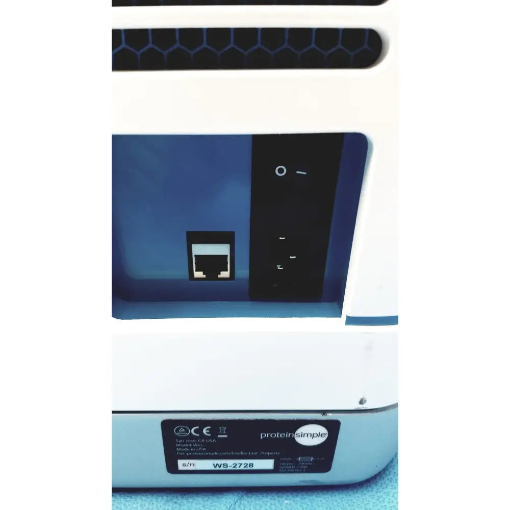White proteinsimple wes analyzer ws-2728 lab instrument with blue interior and black control panel featuring ethernet port