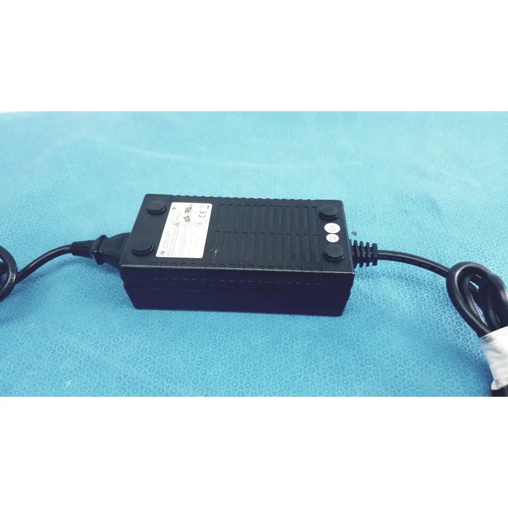 Black ribbed plastic power adapter with two coiled cords protek power model pmp60-12-b16 ac adaptor