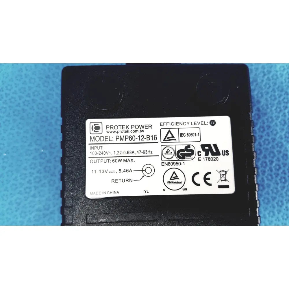 Black plastic protek power model pmp60-12-b16 ac adaptor with white label showing specifications and model number