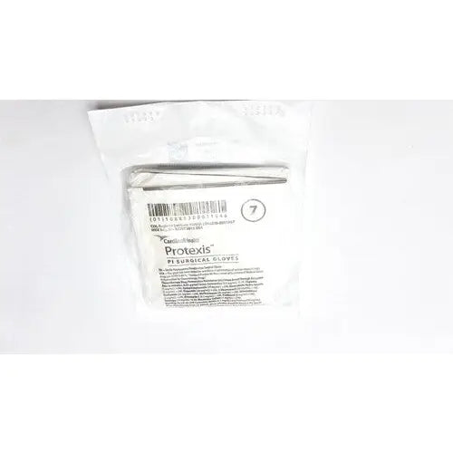 A package of sterile white Protexis surgical glove 2d72pt70x size 7 with barcode and product information visible