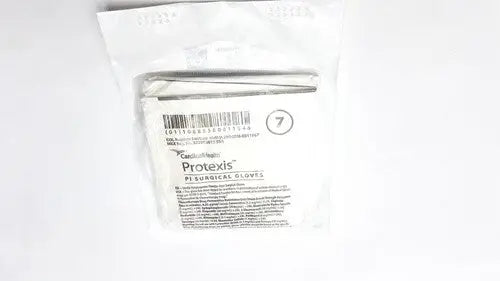A package of sterile white Protexis surgical glove 2d72pt70x size 7 with barcode and product information visible