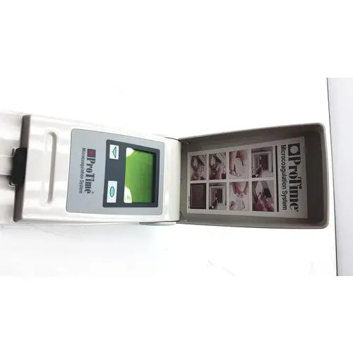 White flip-style opaline protime ivd microcoagulation system with green screen and printed instructional booklet inside cover