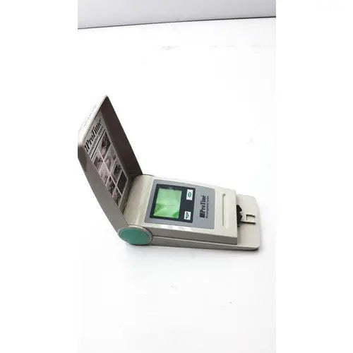 Gray and teal handheld protime microcoagulation l11-01-01 device with small screen buttons and open flip cover for reuse medical