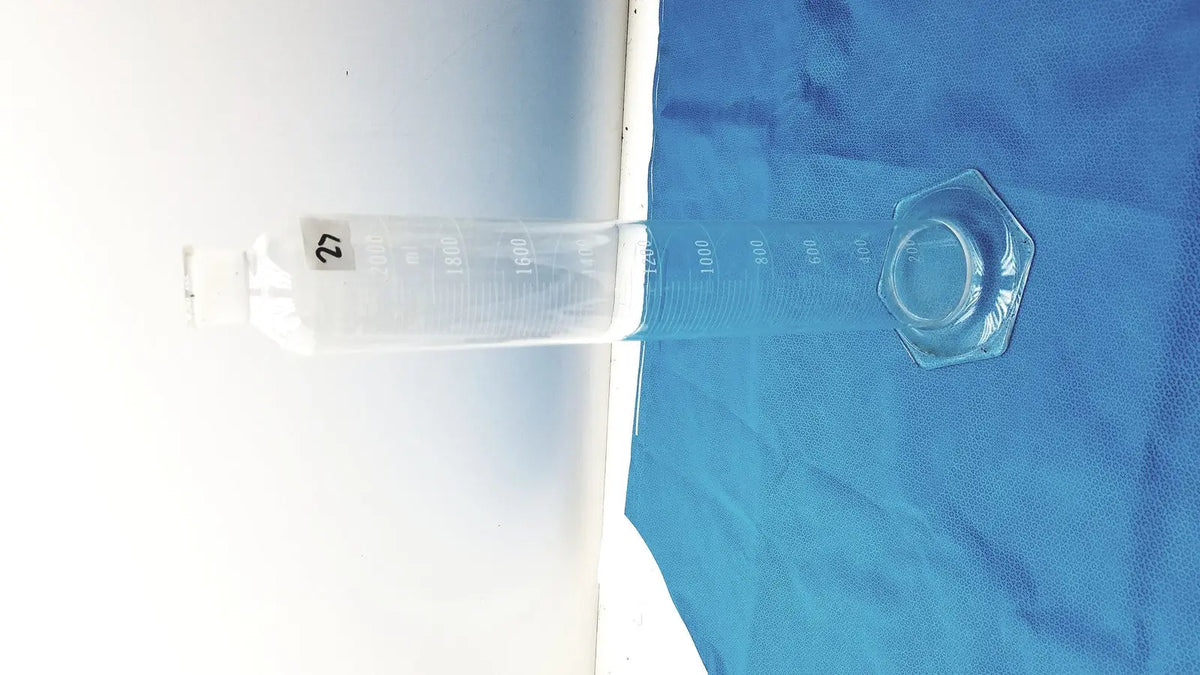 Clear glass pyrex 2000ml graduated cylinder with hexagonal cap and measurement markings for lab use