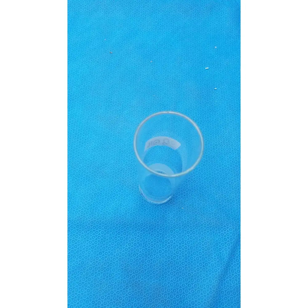 Clear plastic pyrex ground glass drinking glass with smooth cylindrical shape and tapered sides for lab use