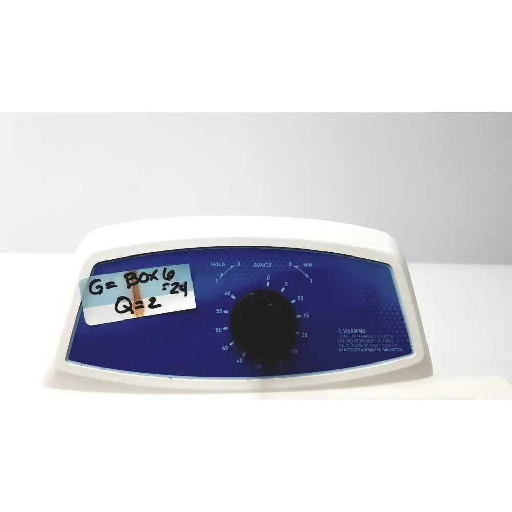 White plastic qsonica c75t ultrasonic cleaner with blue control panel and black rotary dial for timed settings