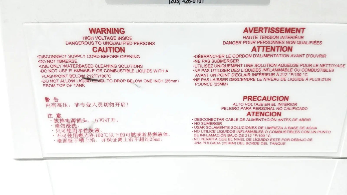 The back label on the white QSonica C75T ultrasonic cleaner displays safety warnings in English and Chinese