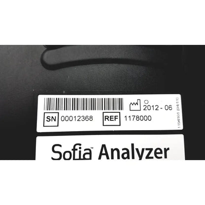 Black quidel sofia laboratory analyzer with white label showing serial number reference code and date on back side