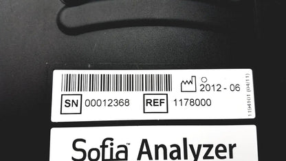 Black quidel sofia laboratory analyzer with white label showing serial number reference code and date on back side
