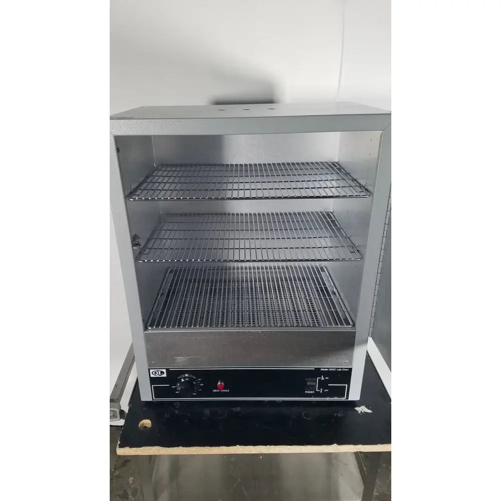 Silver stainless steel three-tier food warmer with wire mesh shelves and black control panel for Quincy Lab 30GC gravity oven