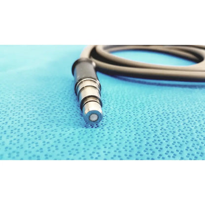 R wolf 8064.40 fiberoptic light cable with sleek metallic 3.5mm audio jack on textured blue surface for surgical illumination
