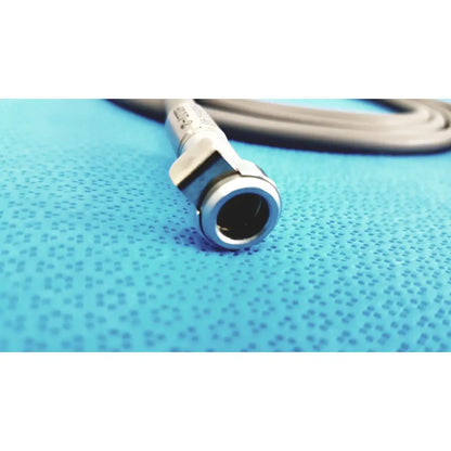 Silver-colored metal fiberoptic light cable connector with cylindrical shape and engraved text for surgical illumination