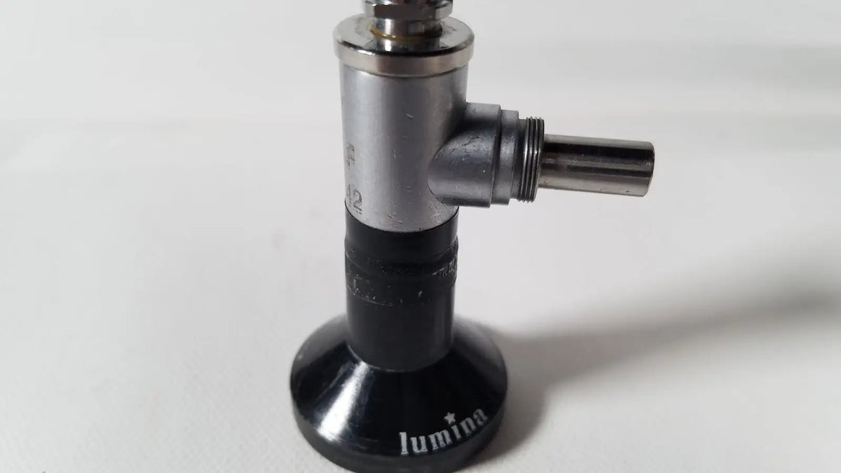 Black and silver luminia gas burner with cylindrical metallic body and threaded nozzle for reuse medical degree rigid arthroscope use