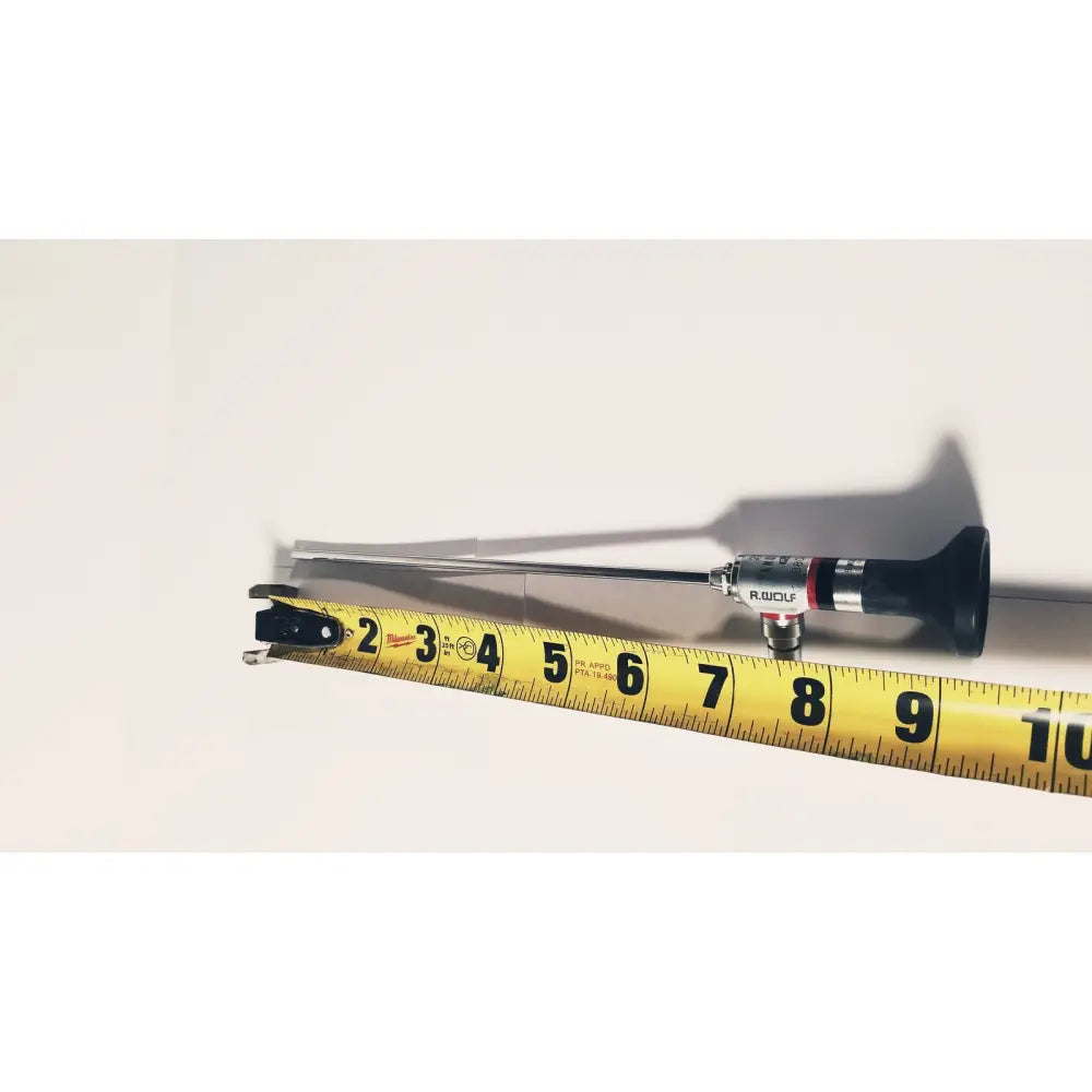A black and silver r-wolf 8880.433 panoview 25 degree rigid arthroscope with a slender metallic shaft beside a yellow measuring tape