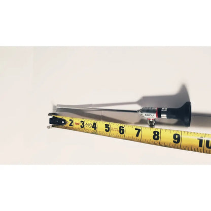 A black and silver r-wolf 8880.433 panoview 25 degree rigid arthroscope with a slender metallic shaft beside a yellow measuring tape
