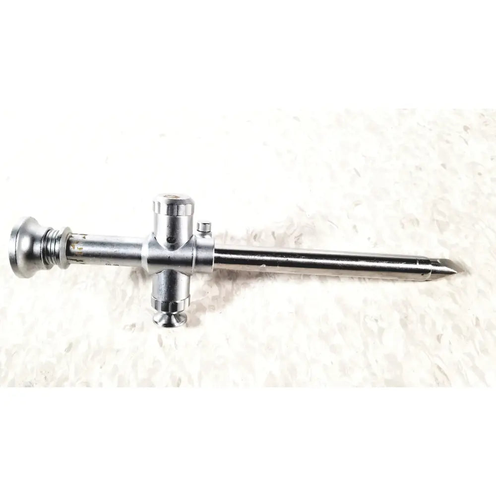 Silver metallic reuse medical trocar 10mm with cross-shaped handle and tapered tip for laparoscopic instruments by r wolf