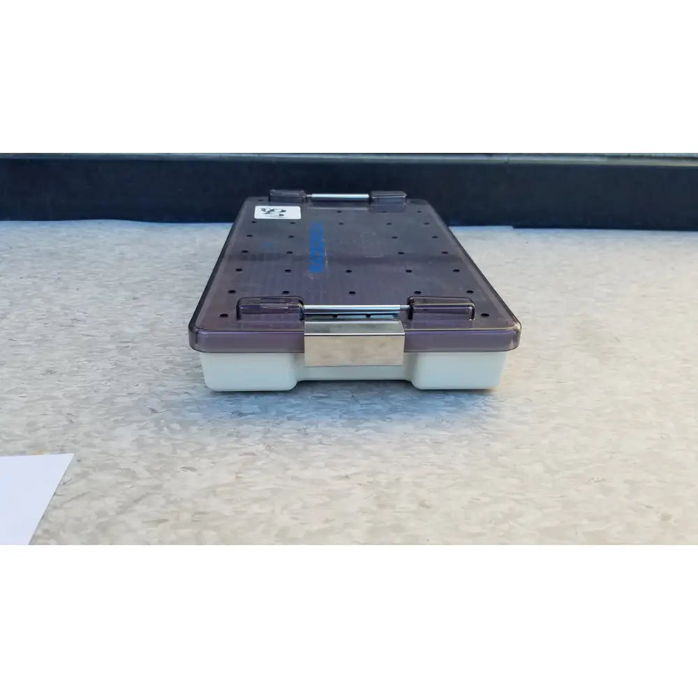 Dark purple transparent plastic radionics surgical sterlization case tray with silver metal latch and white base